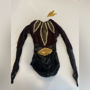 Black with maroon accents and gold rhinestones and appliqués.  Large Child